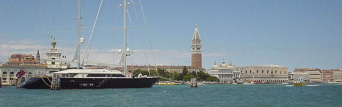 A panoramic view of some of the monuments of Venice taken from a vapporeto en route to St. Marks Square. The domes of St. Mark's Basilica, the campanile of piazza S. Marco, and the rooftop of the Doge's palace all played prominent roles in the history of Venice. The photo was taken from the mouth of the Grand Canal where it opens onto St. Mark's Canal.
